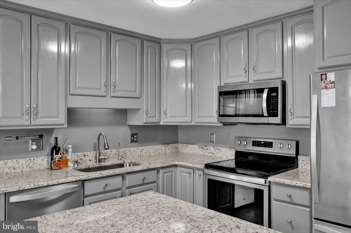 802 Apple Drive Reading, PA 19610 - Photo 22 of 47 a kitchen with white cabinets stainless steel appliances and sink