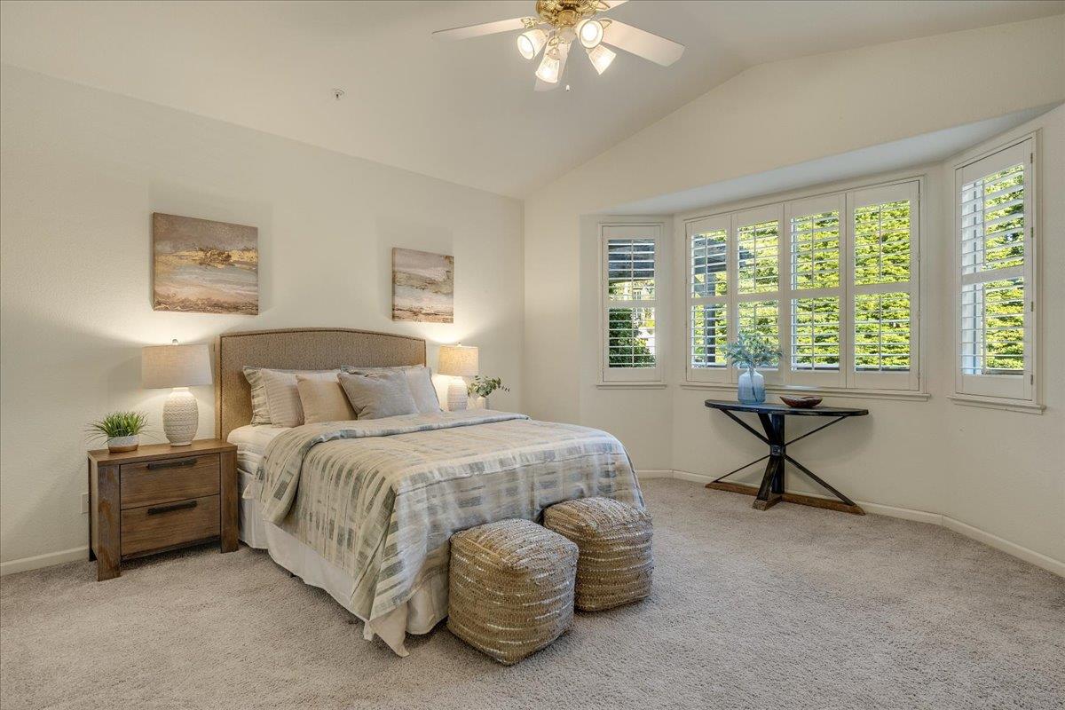 201 Augusta Lane Aptos, CA 95003 - Photo 12 of 36 a bedroom with a bed and a chandelier