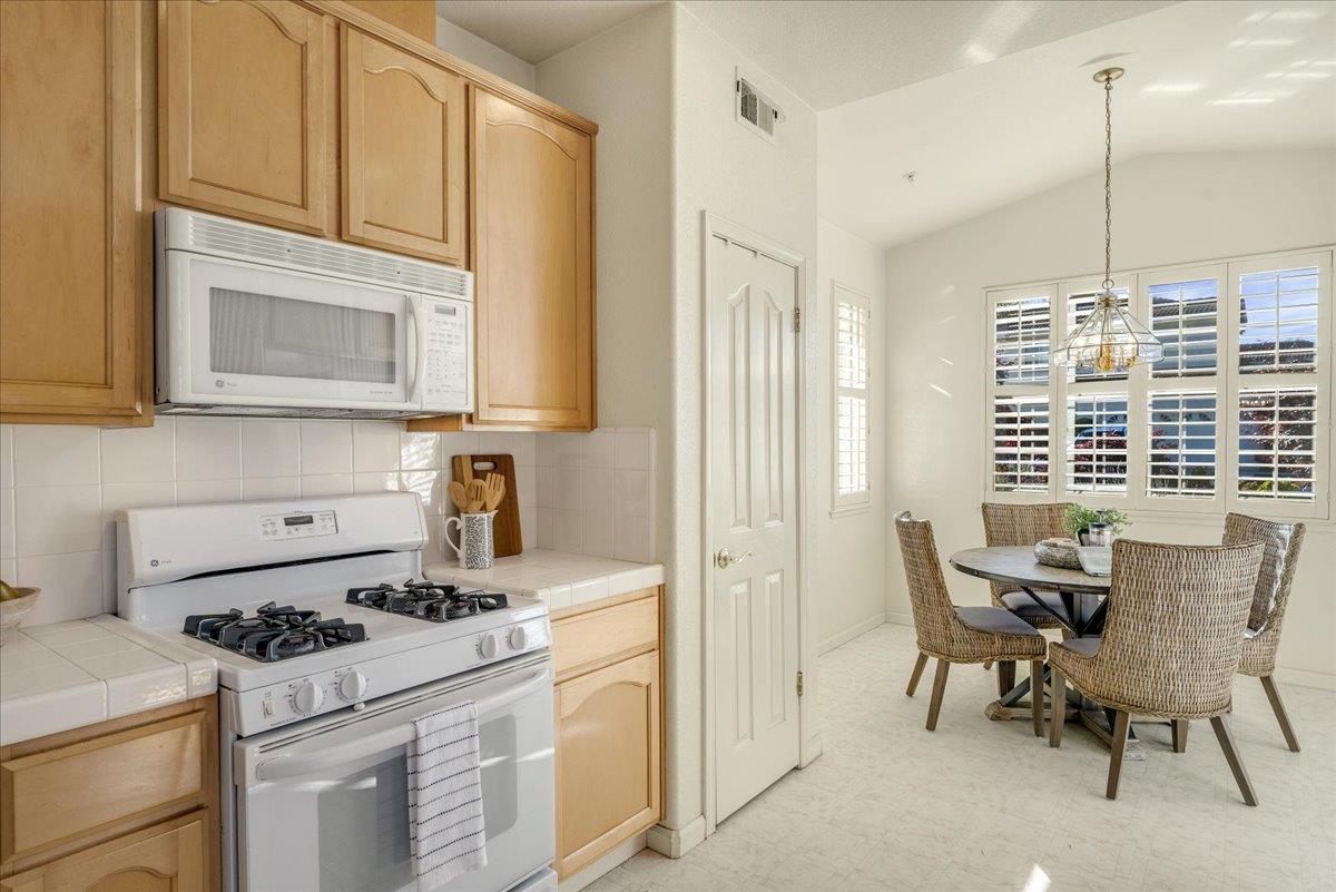 201 Augusta Lane Aptos, CA 95003 - Photo 6 of 36 a kitchen with a stove and white cabinets