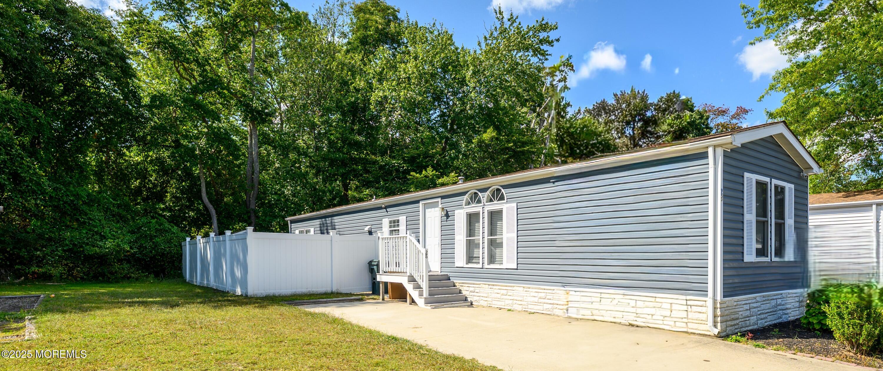 a white house that has a tree in front of it