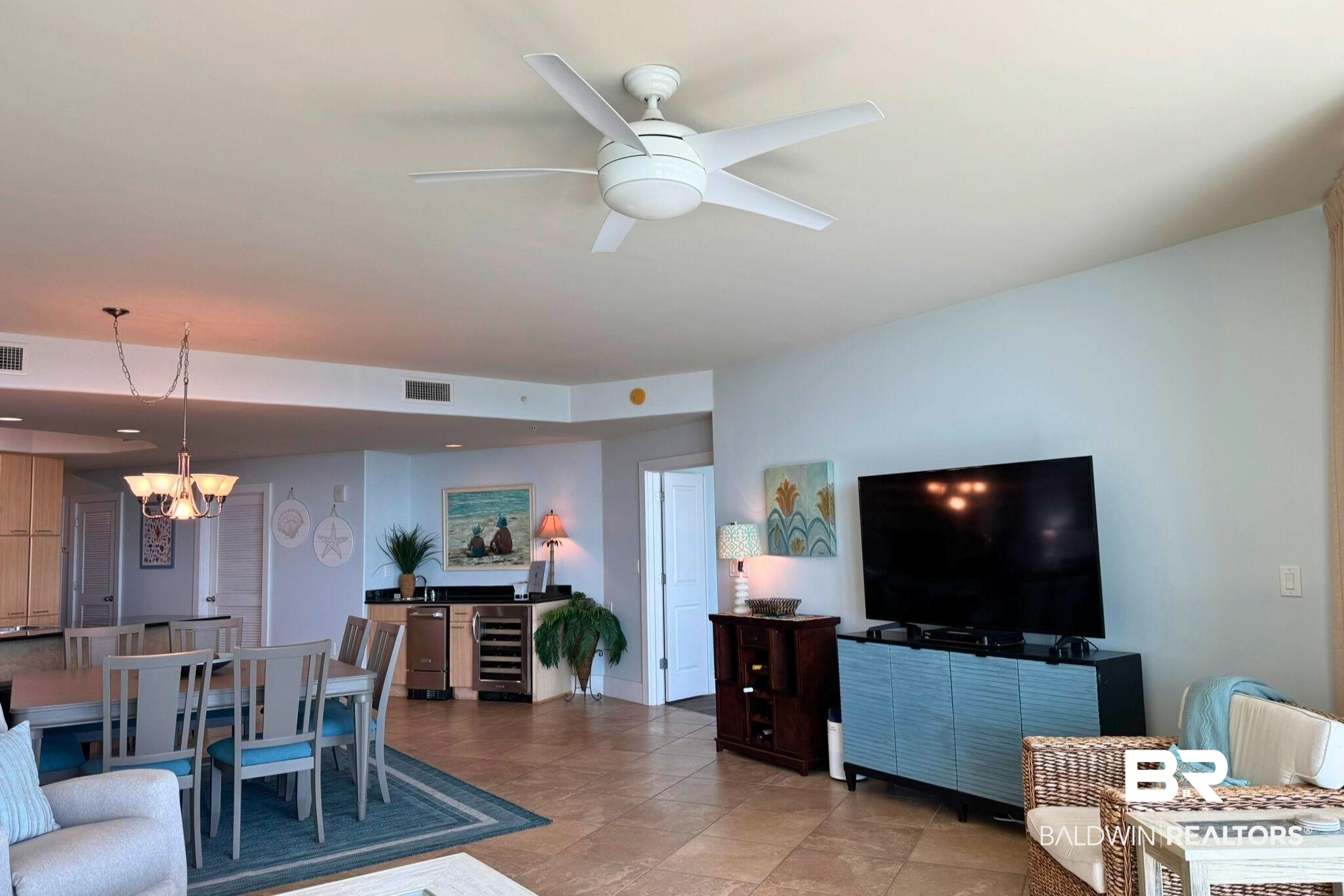 28107 Perdido Beach Boulevard, Unit D714 Orange Beach, AL 36561 - Photo 9 of 88 Living area with ceiling fan with notable chandelier, wine cooler, and visible vents