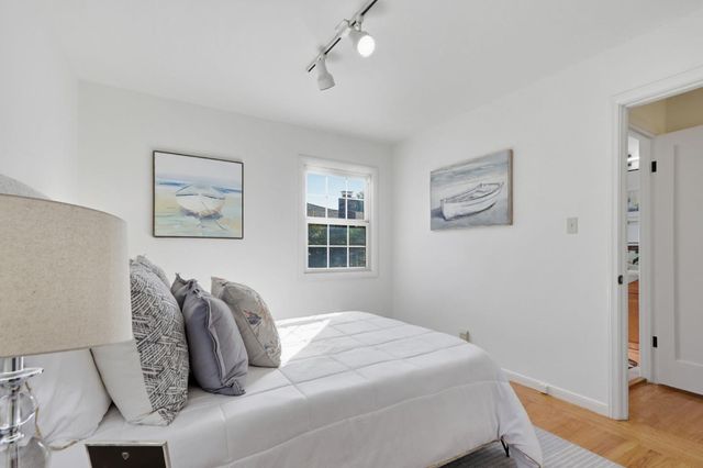 a bedroom with bed and cupboard