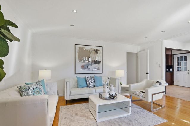 a living room with furniture a rug and a lamp