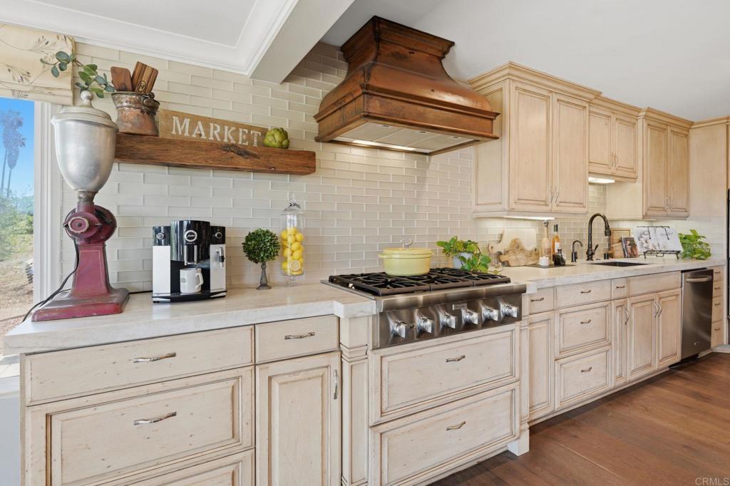 560 Rancho Camino Fallbrook, CA 92028 - Photo 14 of 70 a kitchen with white cabinets and appliances