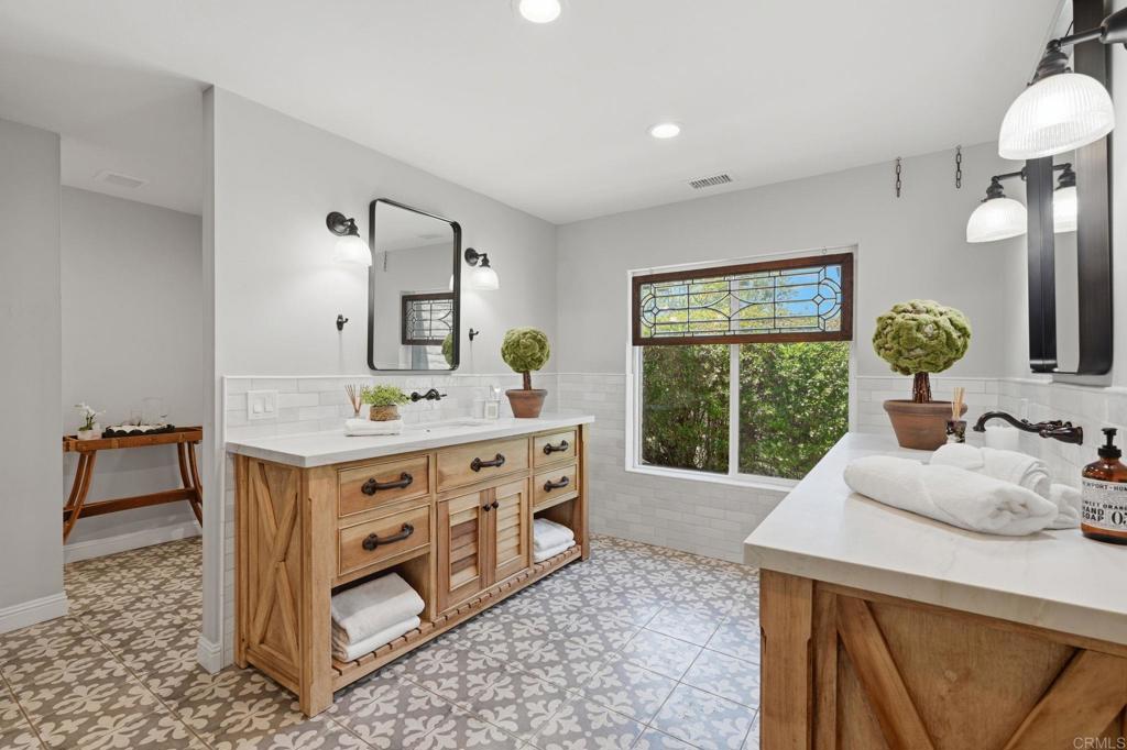 560 Rancho Camino Fallbrook, CA 92028 - Photo 27 of 70 a spacious bathroom with a double vanity sink and a mirror