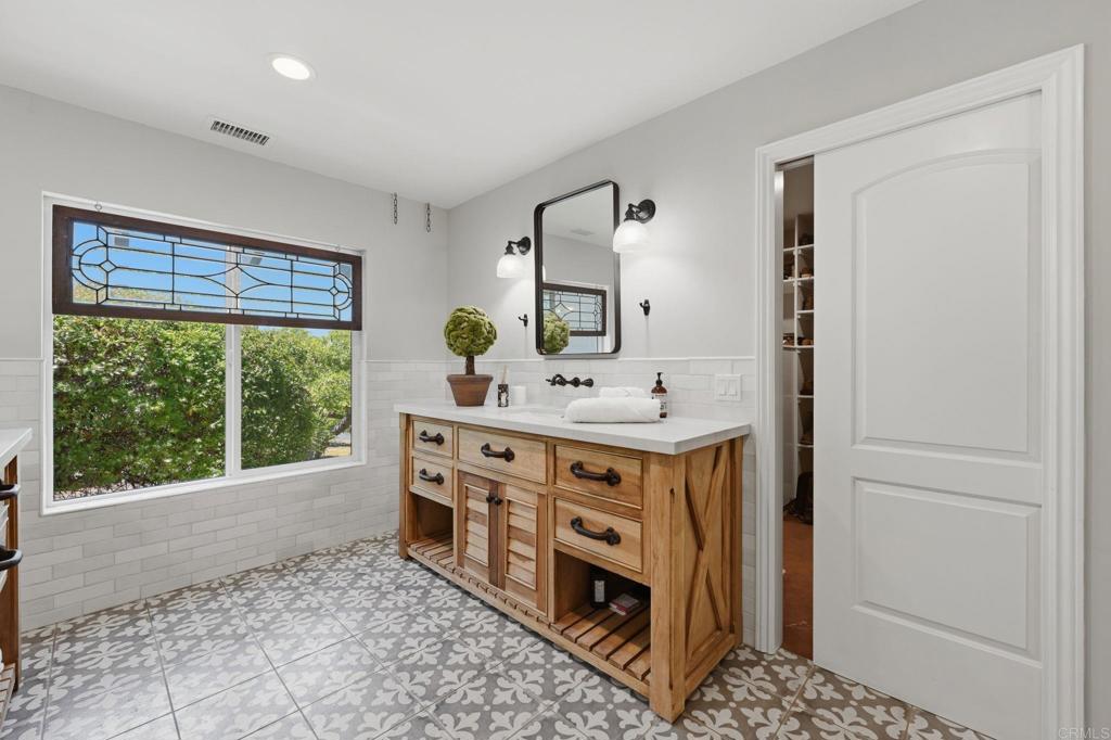 560 Rancho Camino Fallbrook, CA 92028 - Photo 28 of 70 a bathroom with a tub sink and mirror