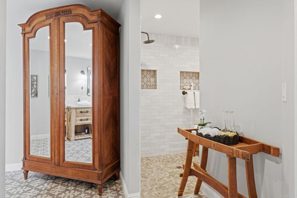 560 Rancho Camino Fallbrook, CA 92028 - Photo 30 of 70 a bathroom with a mirror and a shower