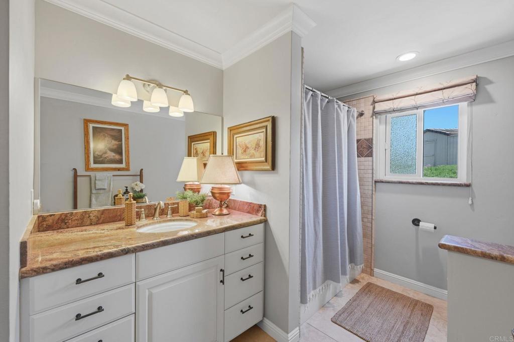 560 Rancho Camino Fallbrook, CA 92028 - Photo 33 of 70 a bathroom with a double vanity sink and a mirror