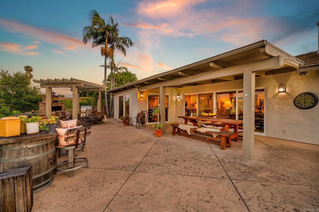 560 Rancho Camino Fallbrook, CA 92028 - Photo 40 of 70 a view of a patio with dining table and chairs under an umbrella
