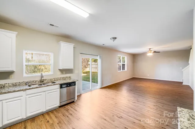 a view of a kitchen with a sink a window and a counter top space