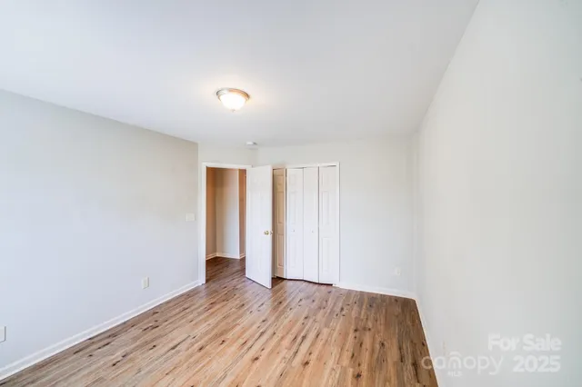 a view of room with wooden floor