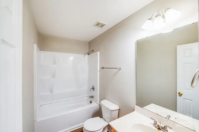 a bathroom with a toilet sink and shower