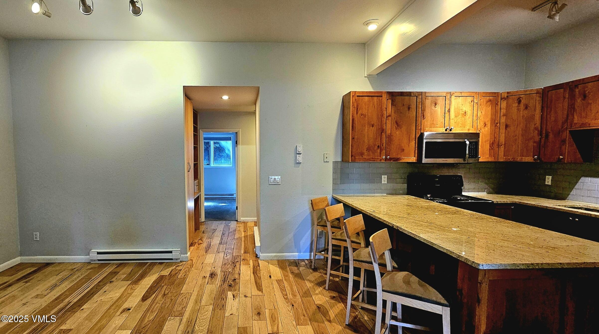 165 Gopher Road, Unit 25 Avon, CO 81620 - Photo 3 of 17 a kitchen that has a microwave and a table in it