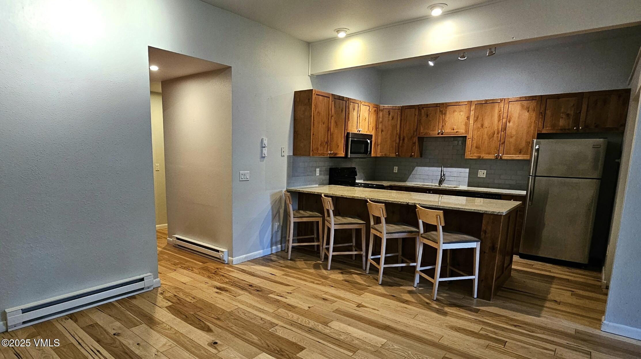 165 Gopher Road, Unit 25 Avon, CO 81620 - Photo 6 of 17 a kitchen with stainless steel appliances a refrigerator and microwave