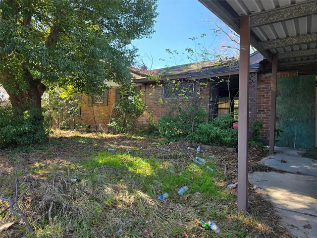 a view of a patio with table and chairs and potted plants