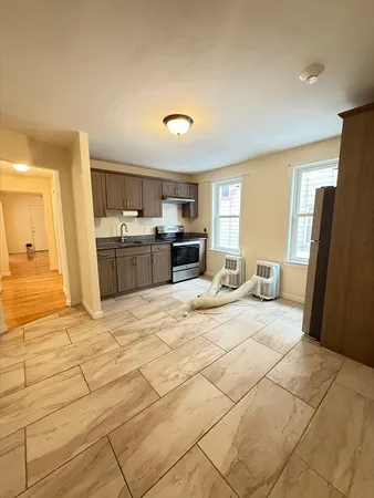 a large bathroom with a sink a mirror and a refrigerator