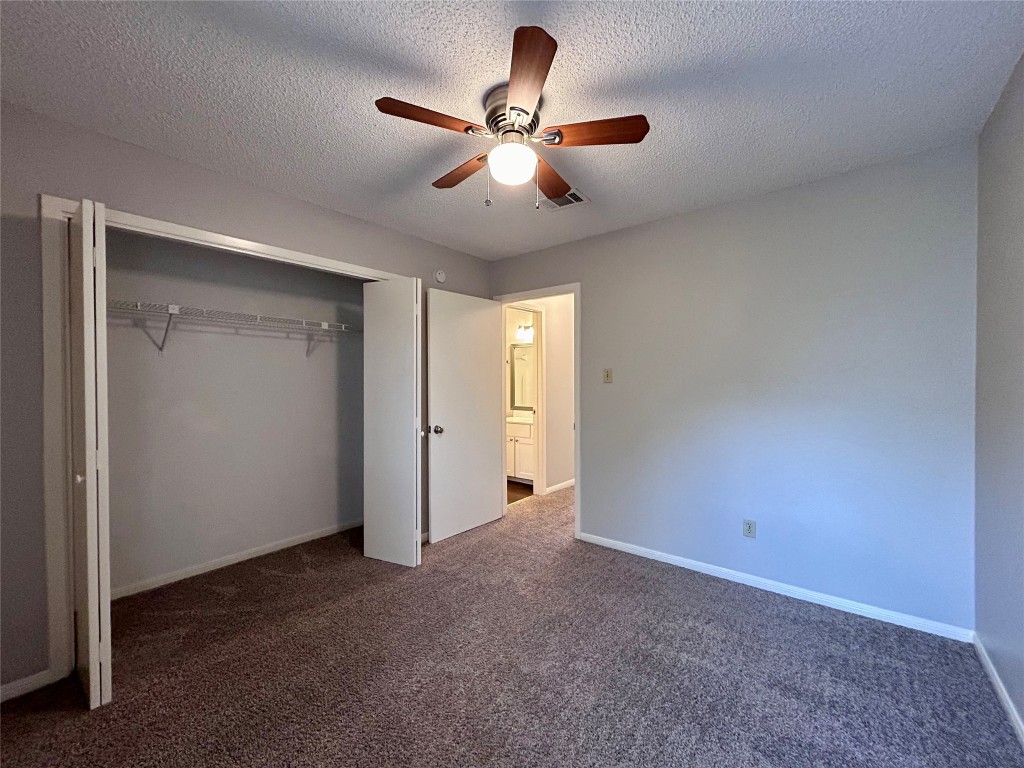 8905 Schick Road, Unit C Austin, TX 78729 - Photo 14 of 25 a view of an empty room and chandelier fan