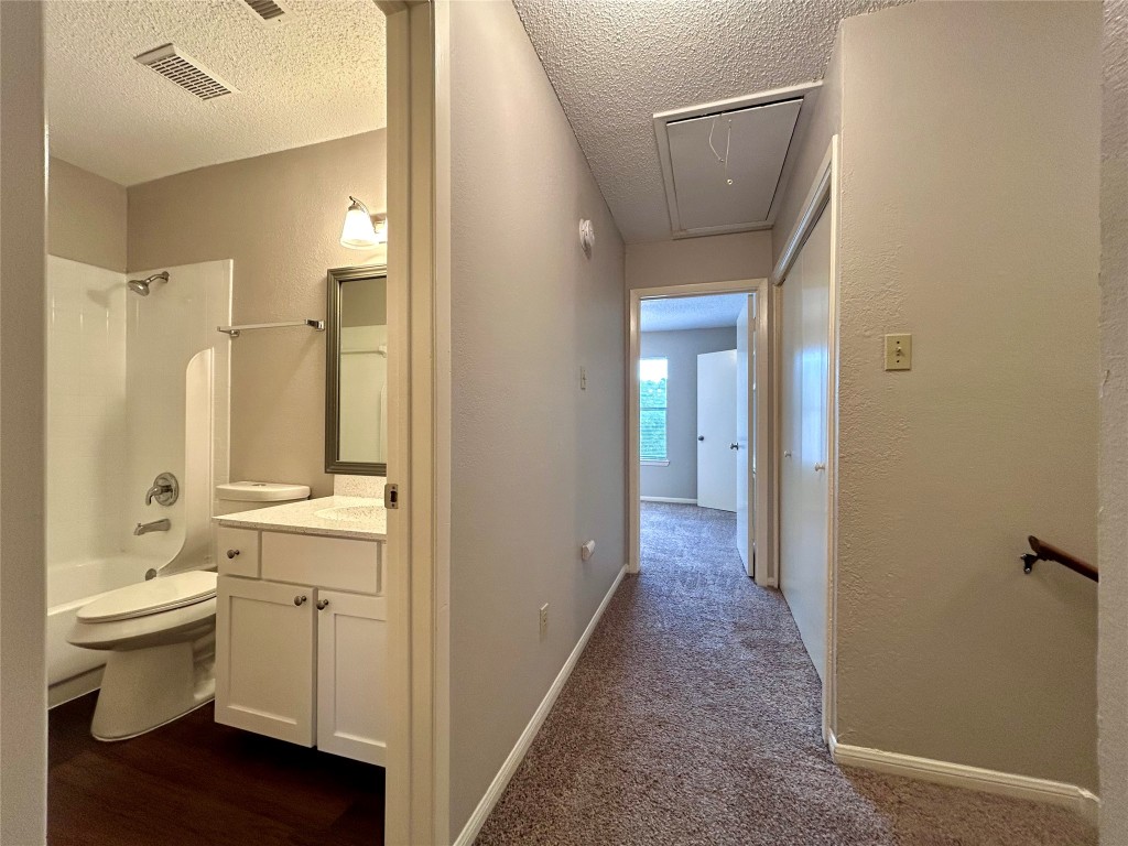 8905 Schick Road, Unit C Austin, TX 78729 - Photo 15 of 25 a bathroom with a sink a toilet and shower