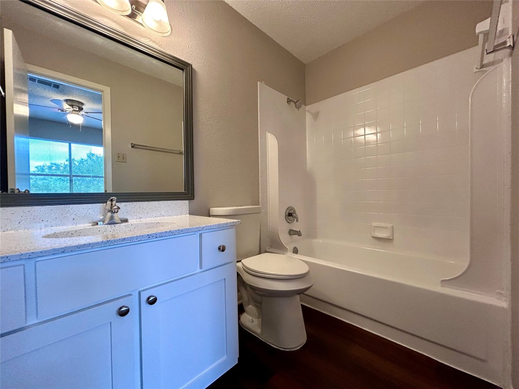 8905 Schick Road, Unit C Austin, TX 78729 - Photo 20 of 25 a bathroom with a sink toilet a mirror and shower