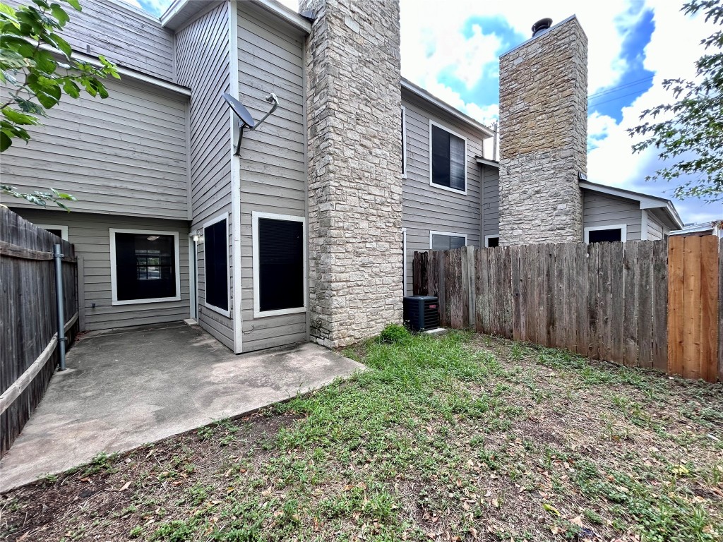 8905 Schick Road, Unit C Austin, TX 78729 - Photo 23 of 25 a view of a house with a backyard and wooden fence