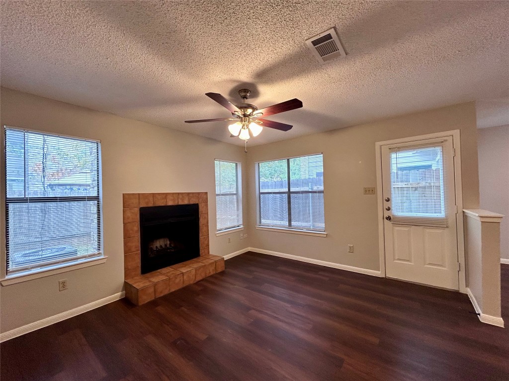 8905 Schick Road, Unit C Austin, TX 78729 - Photo 8 of 25 a view of an empty room with wooden floor and a window