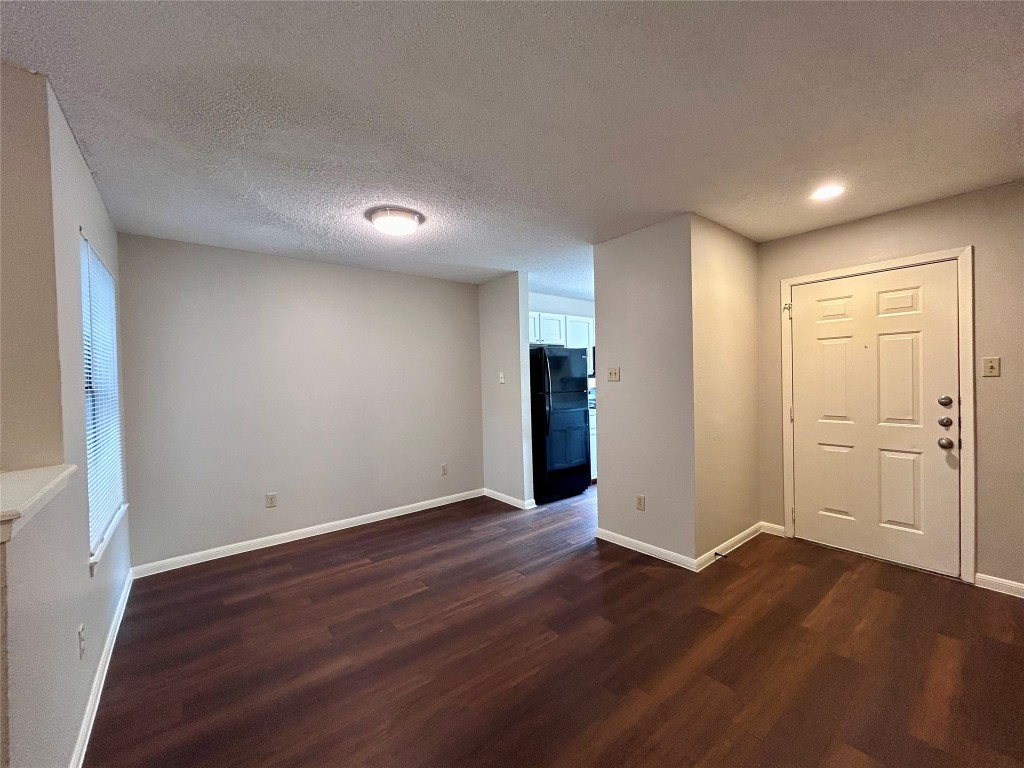8905 Schick Road, Unit C Austin, TX 78729 - Photo 9 of 25 a view of an empty room with wooden floor