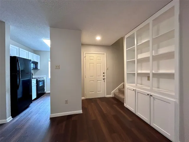 a view of a kitchen with wooden floor and a kitchen