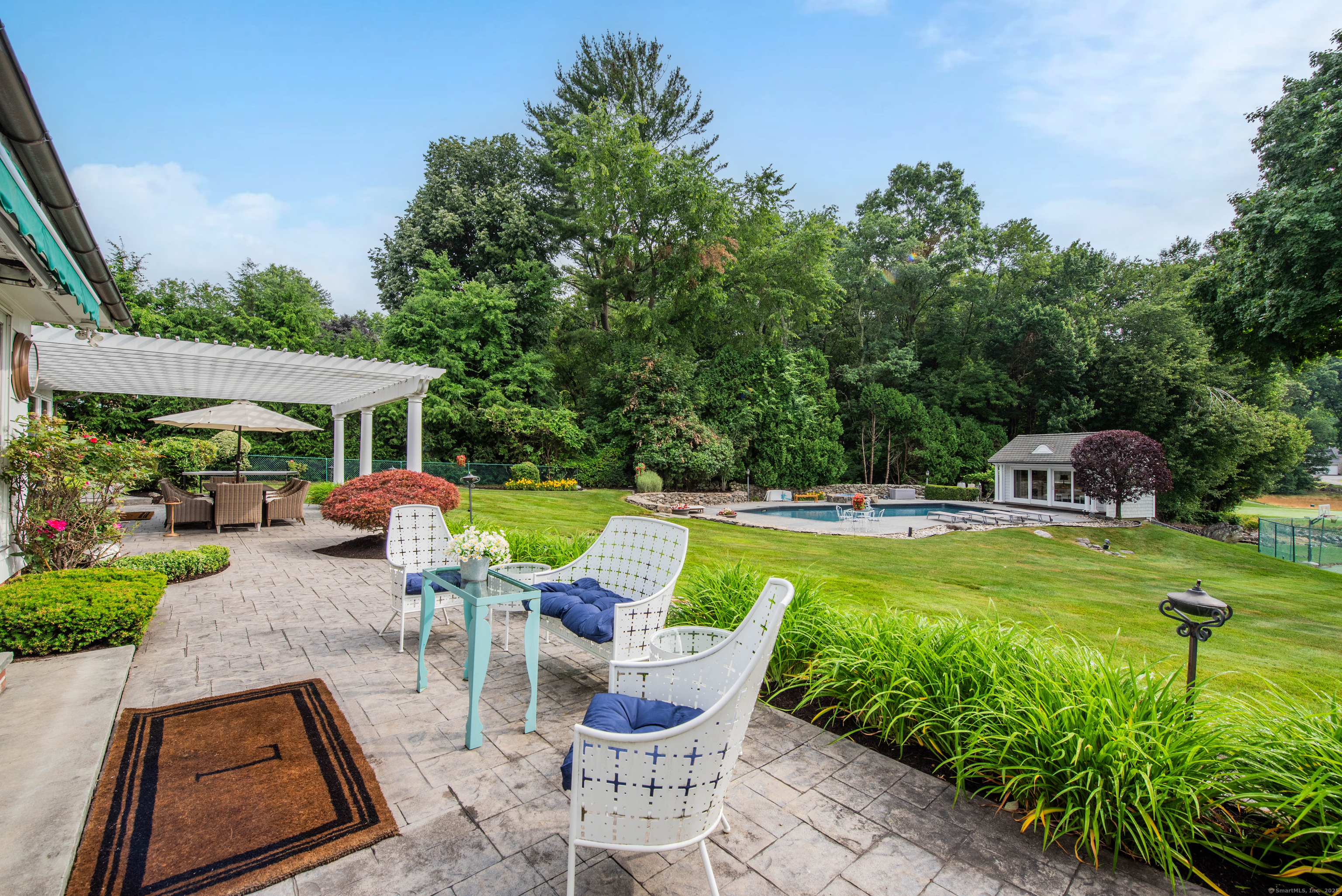 77 Eastfield Road Waterbury, CT 06708 - Photo 17 of 40 a view of a swimming pool and lounge chairs in back yard of the house