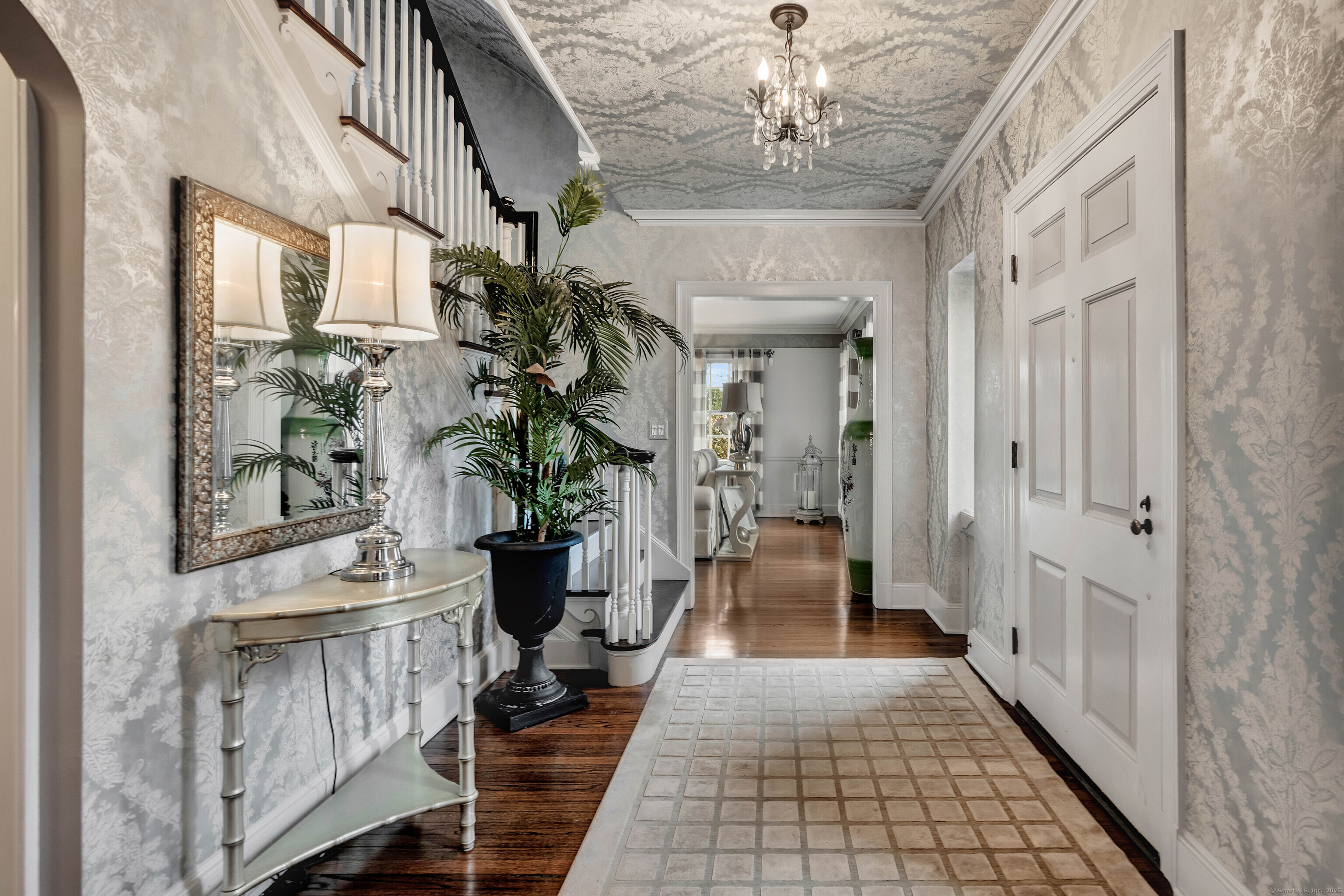 77 Eastfield Road Waterbury, CT 06708 - Photo 33 of 40 a hallway with wooden floor and chandelier