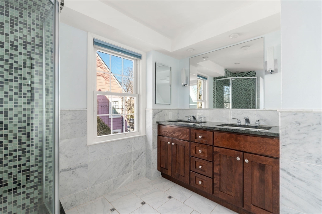 25 Allen Avenue Newton, MA 02468 - Photo 14 of 19 a bathroom with a granite countertop double vanity sink and mirror