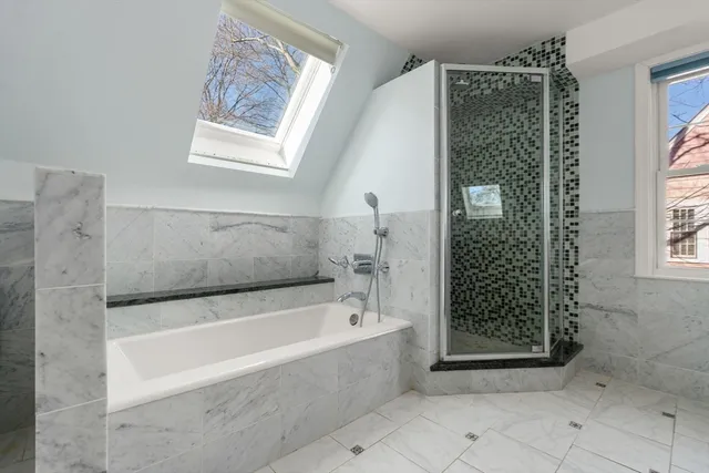 a bathroom with a bathtub and shower