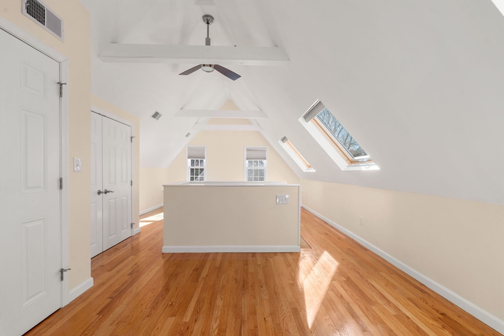 25 Allen Avenue Newton, MA 02468 - Photo 17 of 19 a view of a hallway with wooden floor and staircase