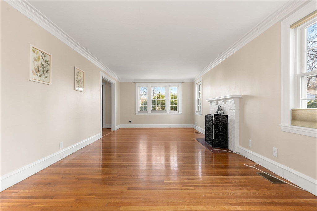 25 Allen Avenue Newton, MA 02468 - Photo 2 of 19 a view of an empty room with window and wooden floor