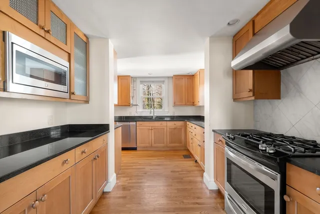 a kitchen with stainless steel appliances granite countertop a stove and a sink
