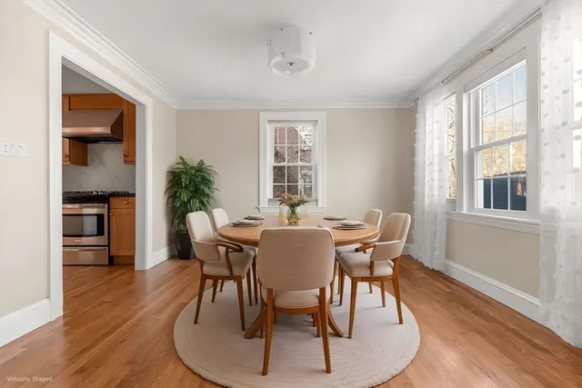 a view of a dining room with furniture window and wooden floor