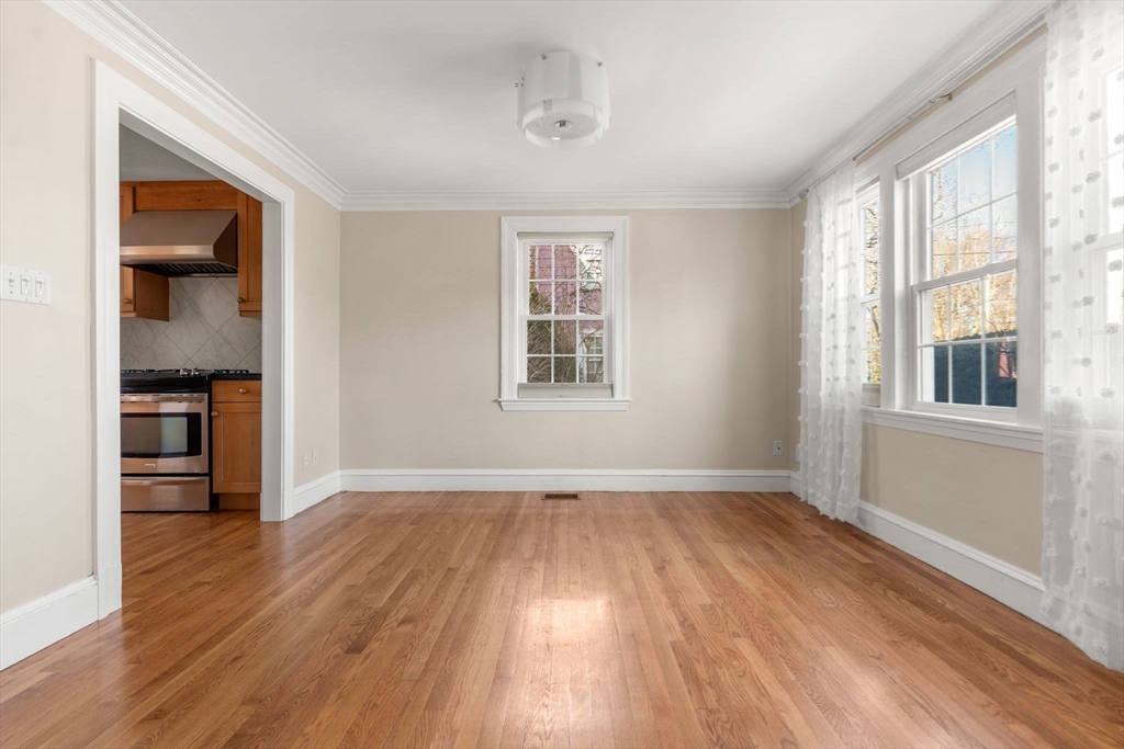 25 Allen Avenue Newton, MA 02468 - Photo 8 of 19 an empty room with wooden floor cabinet and windows