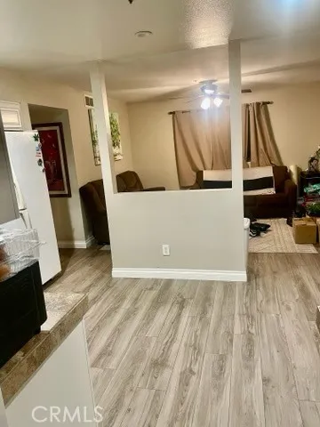 a view of a hallway with wooden floor and workspace