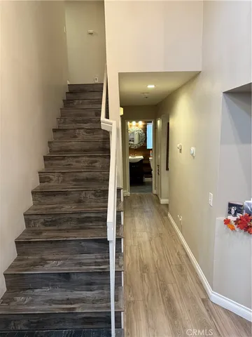 a bedroom with a bed and a flat tv screen on a dresser