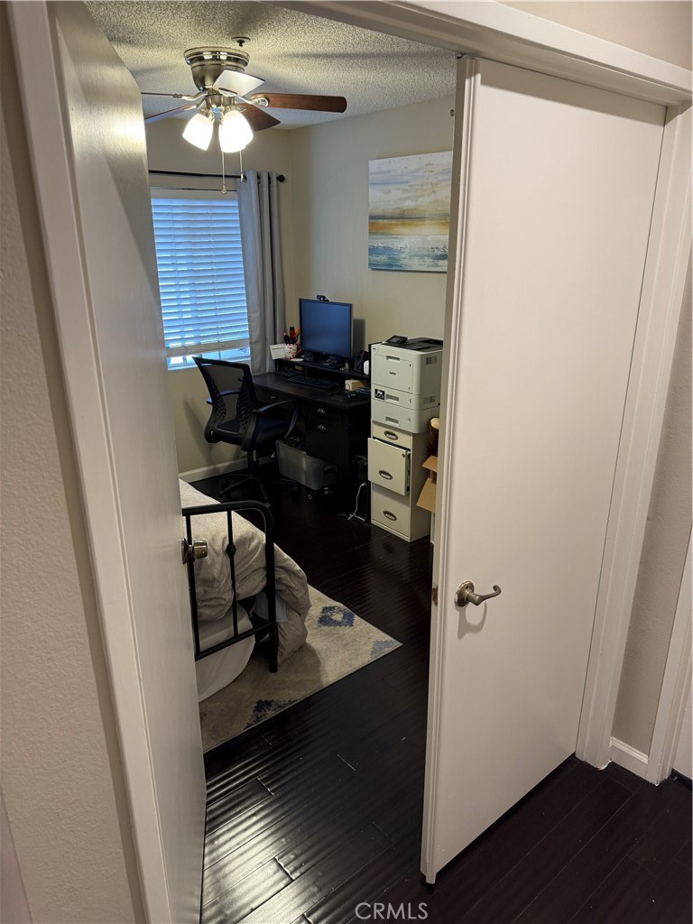 13584 Sutter Court Fontana, CA 92336 - Photo 29 of 46 a view of a hallway with wooden floor and workspace