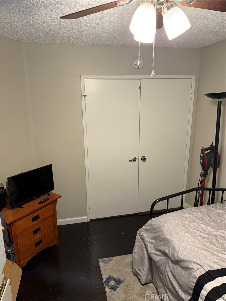 13584 Sutter Court Fontana, CA 92336 - Photo 31 of 46 a bedroom with a bed and a flat tv screen on a dresser