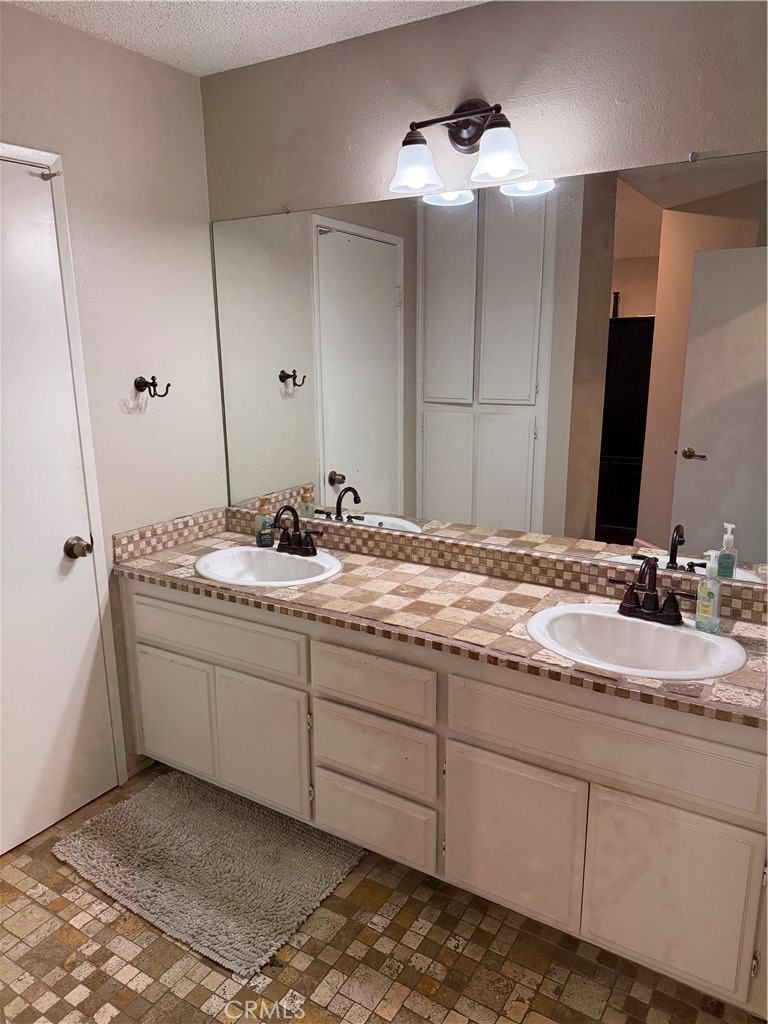 13584 Sutter Court Fontana, CA 92336 - Photo 37 of 46 a bathroom with a sink and a mirror