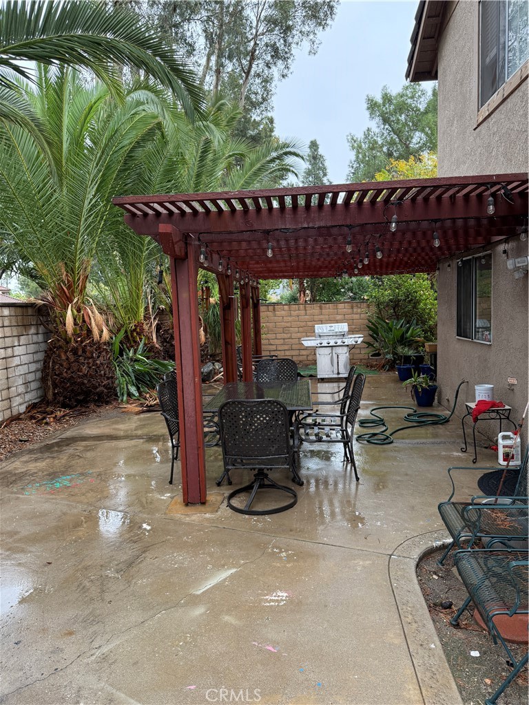 13584 Sutter Court Fontana, CA 92336 - Photo 42 of 46 a view of a patio with table and chairs potted plants and large tree
