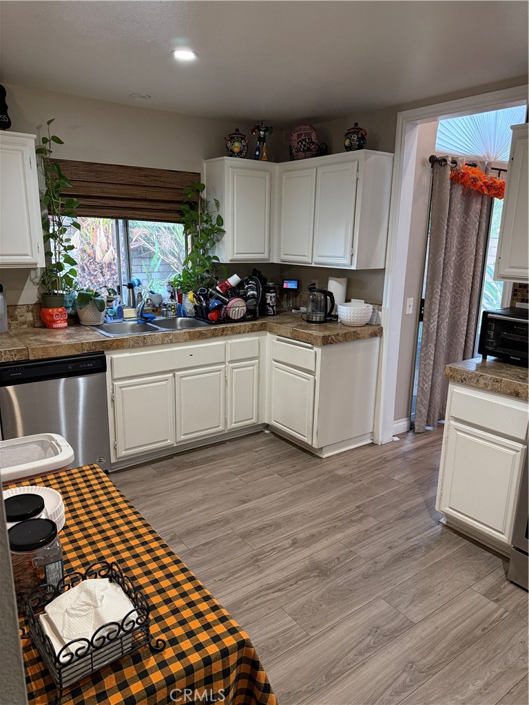 13584 Sutter Court Fontana, CA 92336 - Photo 10 of 46 a kitchen with granite countertop a sink cabinets and stainless steel appliances