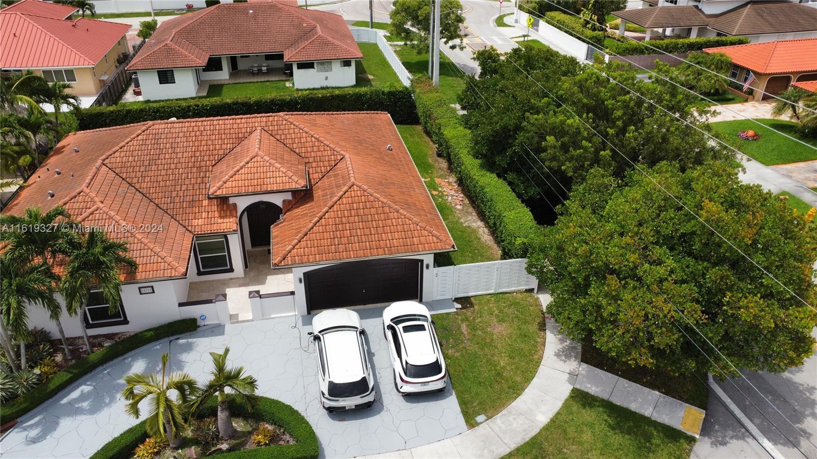 14201 Southwest 15th Street Miami, FL 33184 - Photo 2 of 37 an aerial view of a house with garden space and sitting area