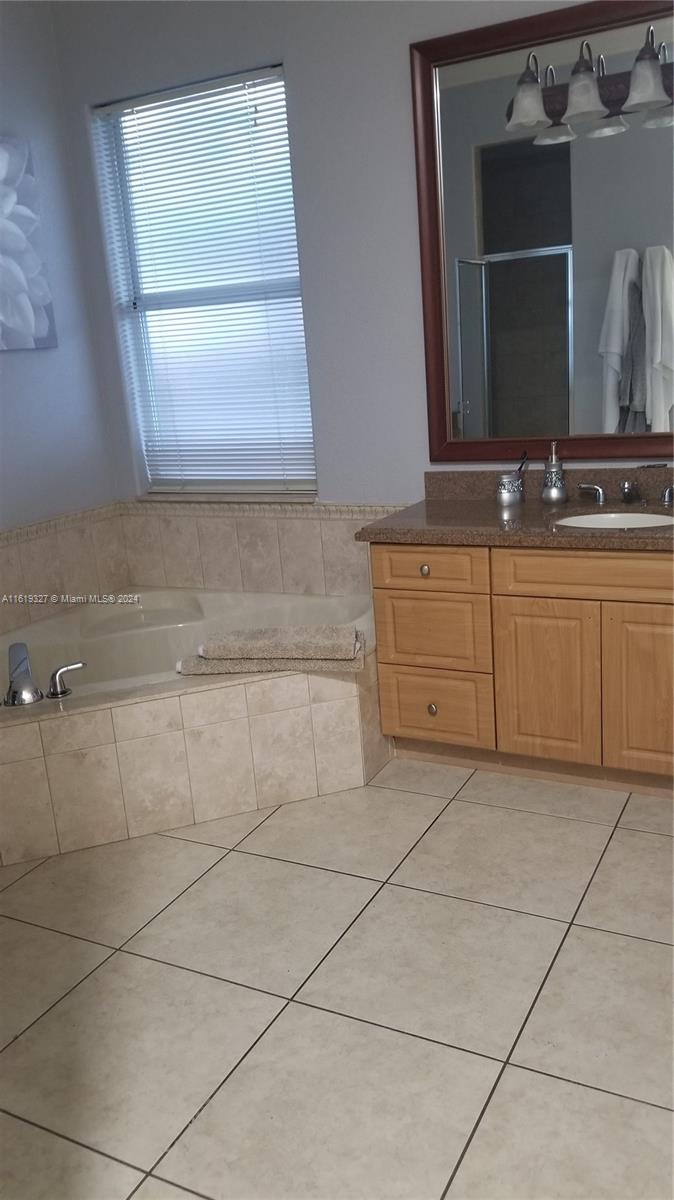 14201 Southwest 15th Street Miami, FL 33184 - Photo 23 of 37 a bathroom with a sink and a mirror