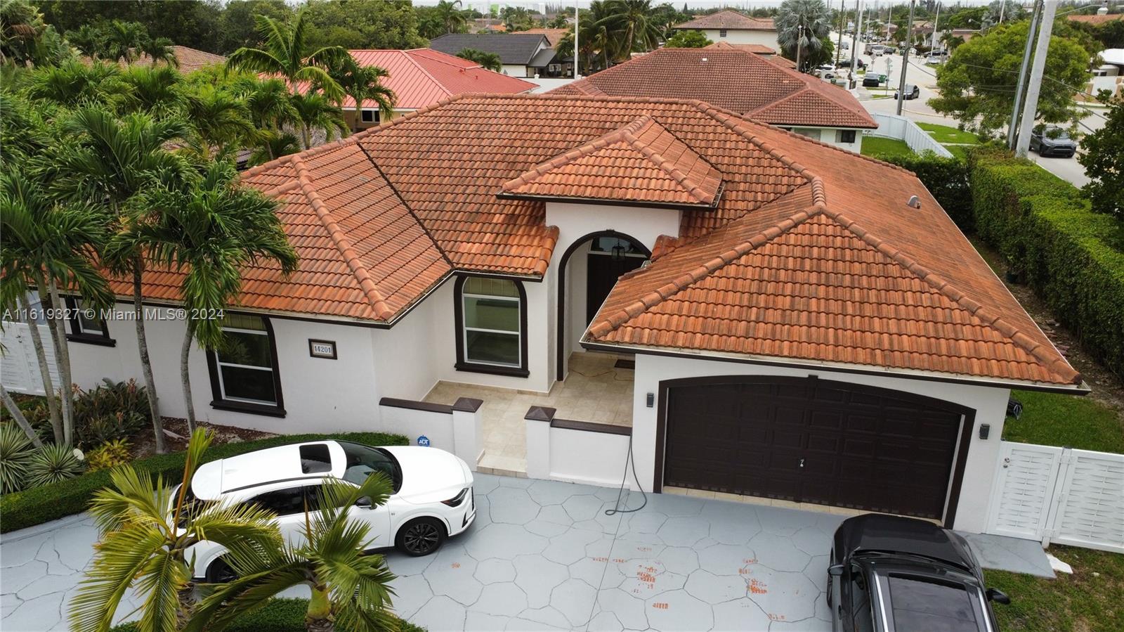 14201 Southwest 15th Street Miami, FL 33184 - Photo 32 of 37 a front view of a house with a garden