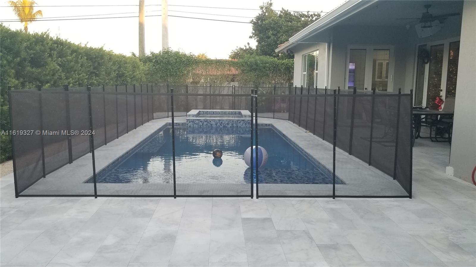 14201 Southwest 15th Street Miami, FL 33184 - Photo 8 of 37 a backyard of a house with table and chairs