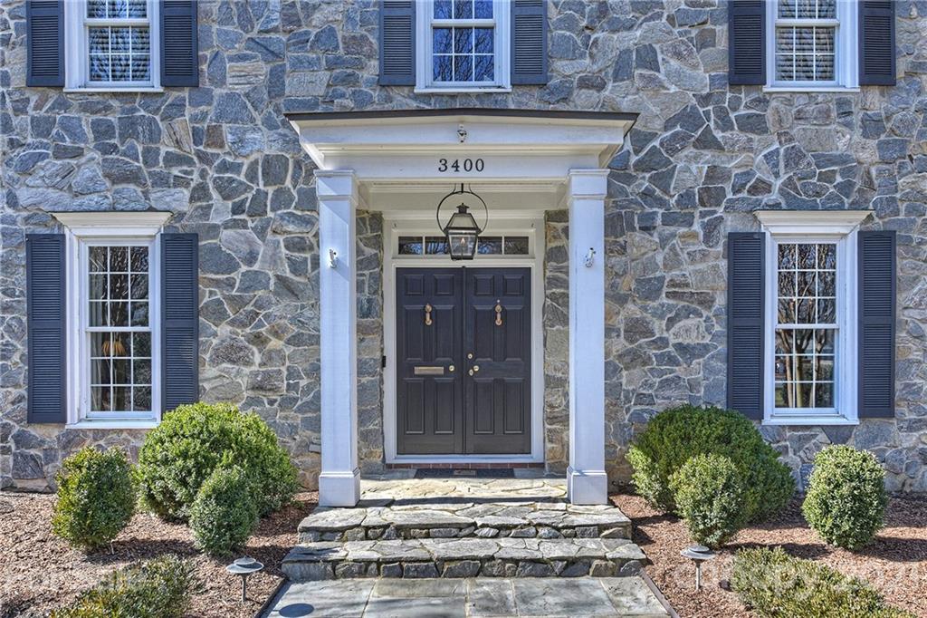 3400 Sharon Road Charlotte, NC 28211 - Photo 2 of 38 a front view of a house with a yard