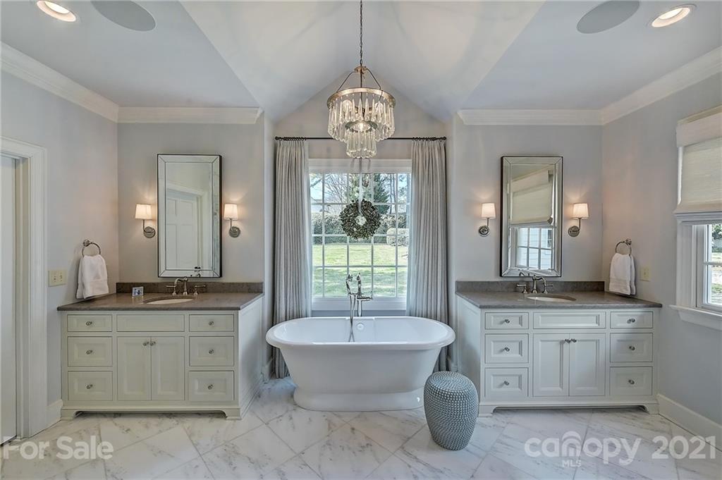 3400 Sharon Road Charlotte, NC 28211 - Photo 11 of 38 a spacious bathroom with a granite countertop sink and a mirror