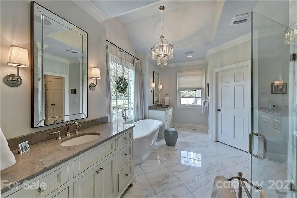 3400 Sharon Road Charlotte, NC 28211 - Photo 12 of 38 a spacious bathroom with a granite countertop sink a mirror a shower and a bathtub